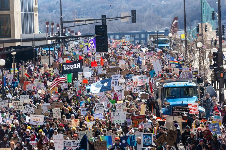 People march during the "No Kings" rally in St Paul, Minnesota